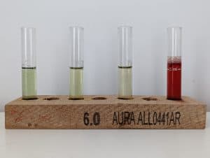 Aquarium water test tubes in a wood block stand.